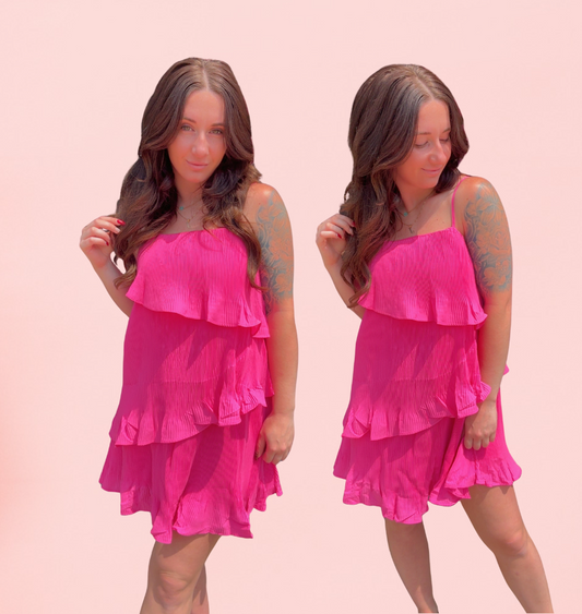 Woman wearing a pink dress against a pink background